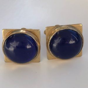 Vintage gold tone cuff links with blue stone.